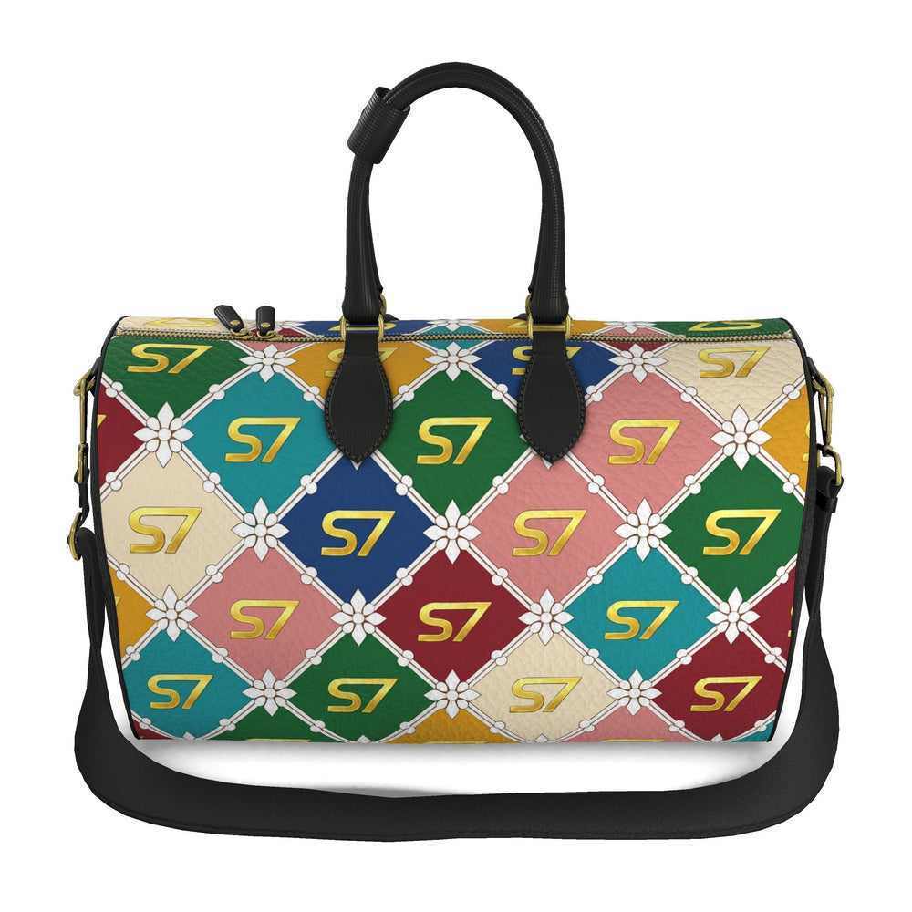 S7 Harlequin Royale leather duffle with yellow-gold S7 monograms, white floral diamond lattice, multicolor panels, black handles, and gold-tone hardware.