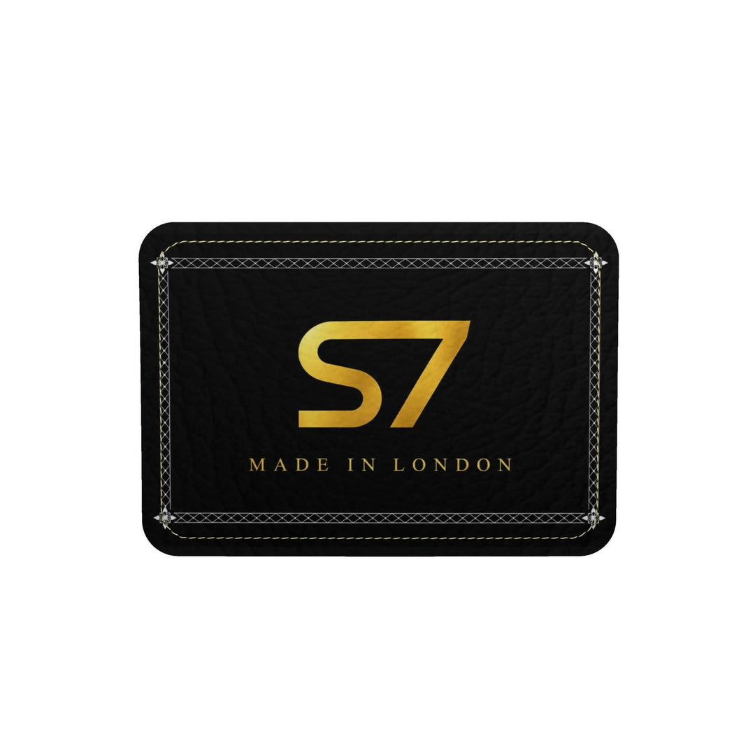 S7 Harlequin Royale leather duffle with yellow-gold S7 monograms, white floral diamond lattice, multicolor panels, black handles, and gold-tone hardware.