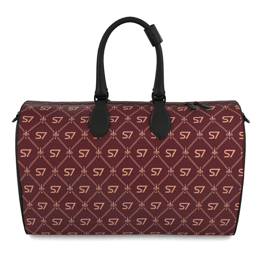S7 Burgundy Royale leather mini duffle bag with rose-gold-tone S7 monograms and ornate diamond lattice on burgundy, framed by black sides and handles.