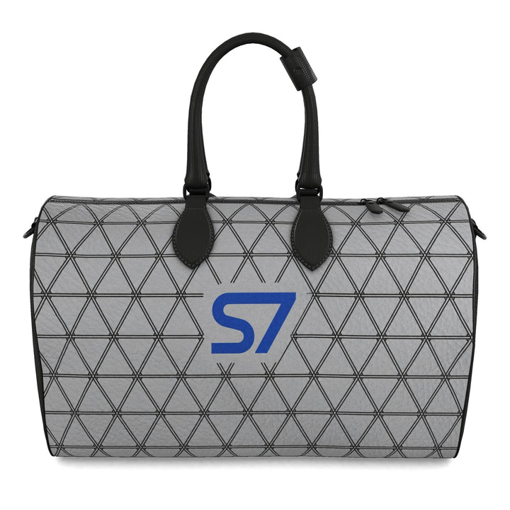 S7 PRISM duffle bag featuring black triangular lattice on a heather-gray background with a single cobalt-blue S7 logo.