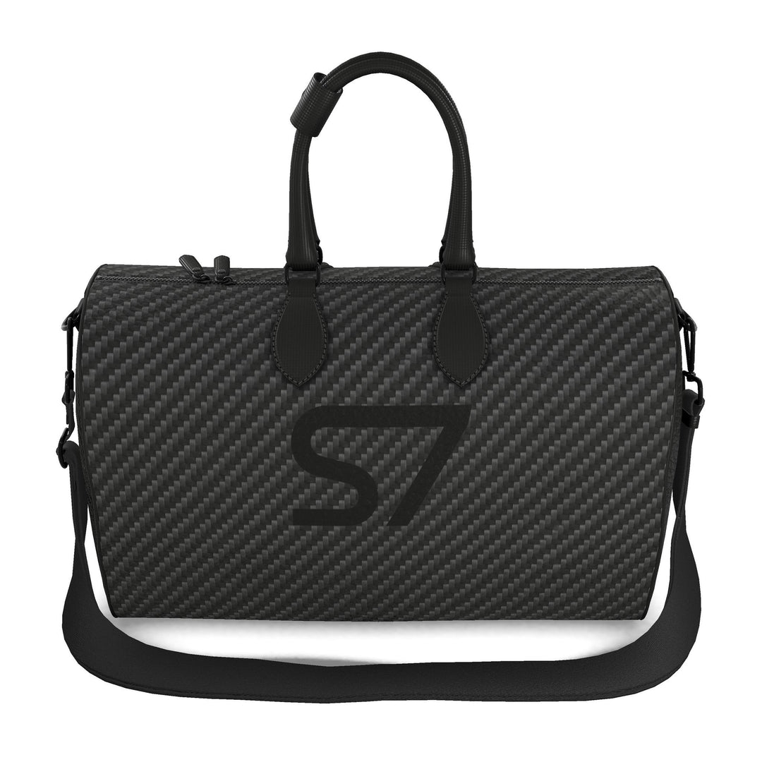 S7 Carbon Noir leather duffle bag with a graphite carbon-fiber-inspired print, centered black S7 monogram, black handles and solid black end panels.