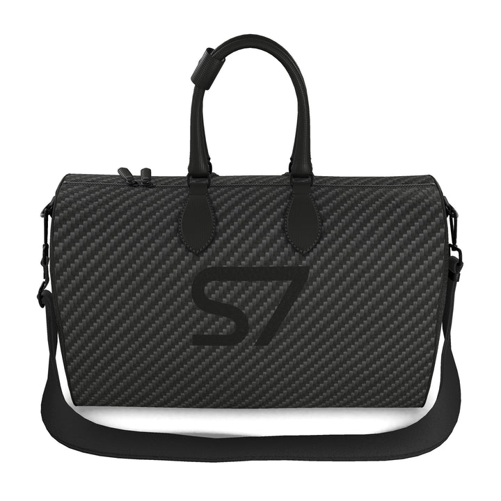 S7 Carbon Noir leather duffle bag with a graphite carbon-fiber-inspired print, centered black S7 monogram, black handles and solid black end panels.