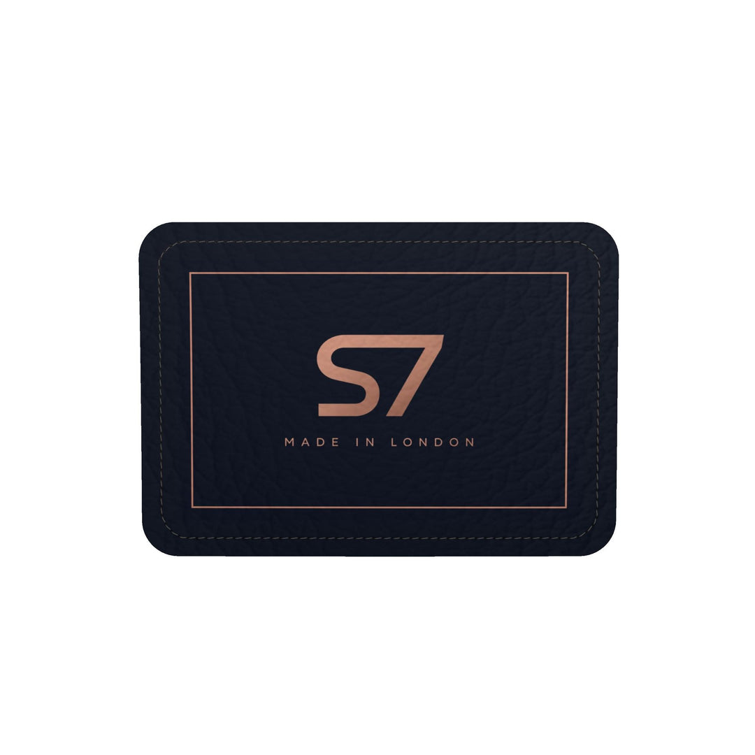 S7 Midnight Terrain leather duffle bag with midnight-blue, navy, beige, brown and black camouflage, a centered rose-gold S7 monogram and black trim.
