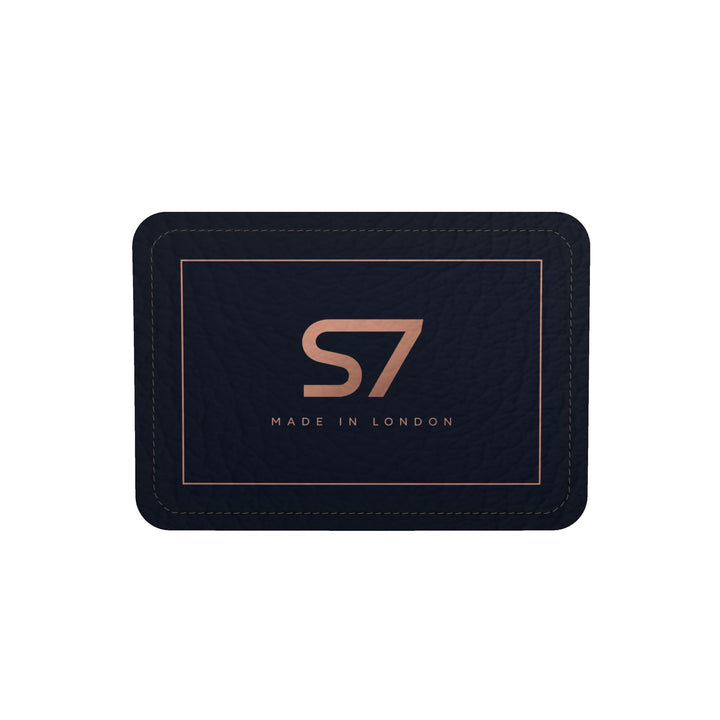 S7 Midnight Terrain leather duffle bag with midnight-blue, navy, beige, brown and black camouflage, a centered rose-gold S7 monogram and black trim.