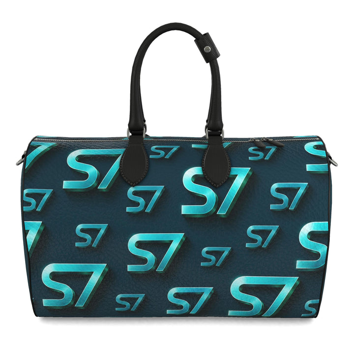 S7 Electric Lagoon bag featuring dimensional turquoise monograms, midnight teal side panels, and nickel-tone hardware.