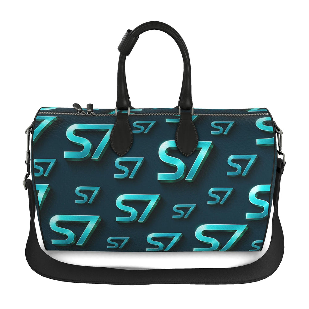 S7 Electric Lagoon bag featuring dimensional turquoise monograms, midnight teal side panels, and nickel-tone hardware.