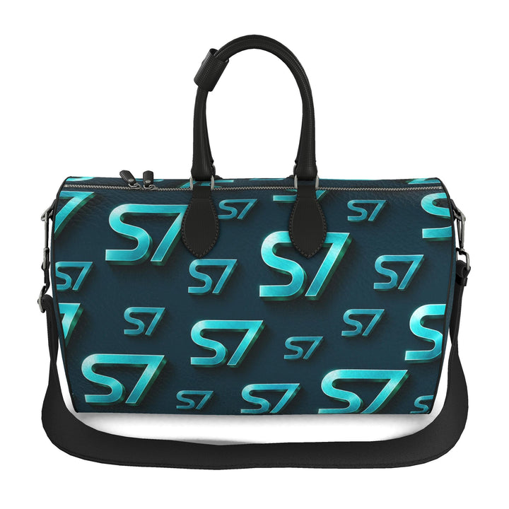 S7 Electric Lagoon bag featuring dimensional turquoise monograms, midnight teal side panels, and nickel-tone hardware.