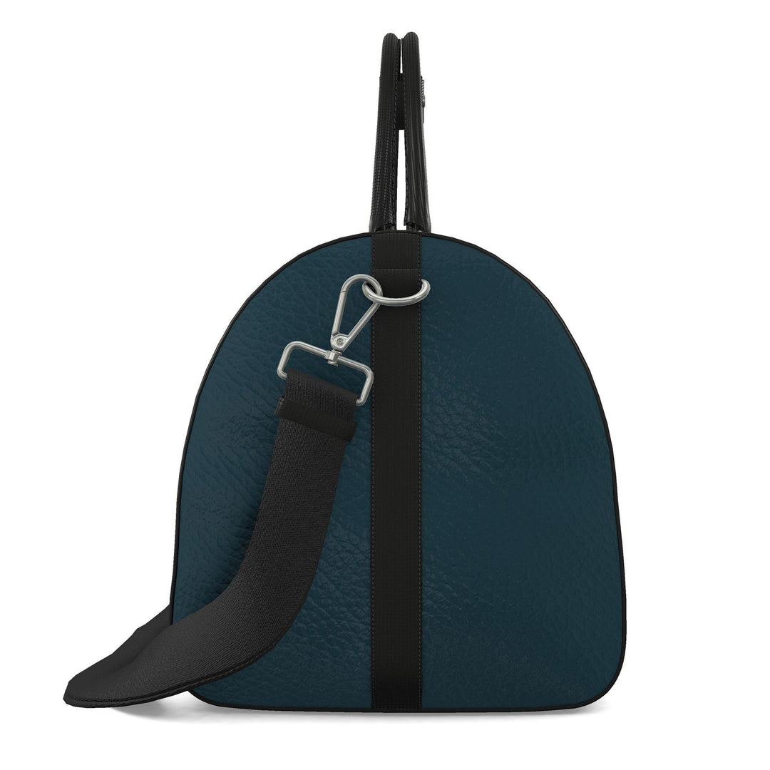 S7 Electric Lagoon bag featuring dimensional turquoise monograms, midnight teal side panels, and nickel-tone hardware.