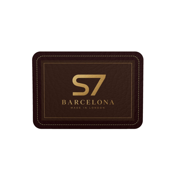 S7 Barcelona Mediterranean Mosaic leather duffle bag with colorful landmark artwork, brown side panels, black handles, and gold-tone hardware.