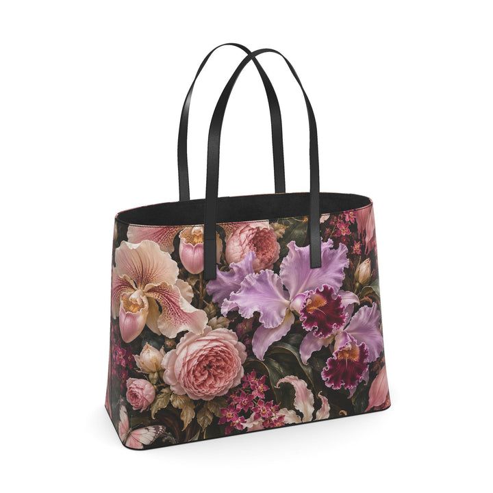 S7 Orchid Reverie leather tote bag featuring blush and lilac flowers, two butterflies, and gold-toned botanical artwork on deep plum with black handles.
