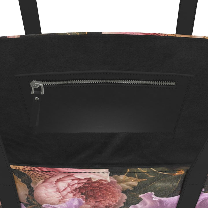 S7 Orchid Reverie leather tote bag featuring blush and lilac flowers, two butterflies, and gold-toned botanical artwork on deep plum with black handles.