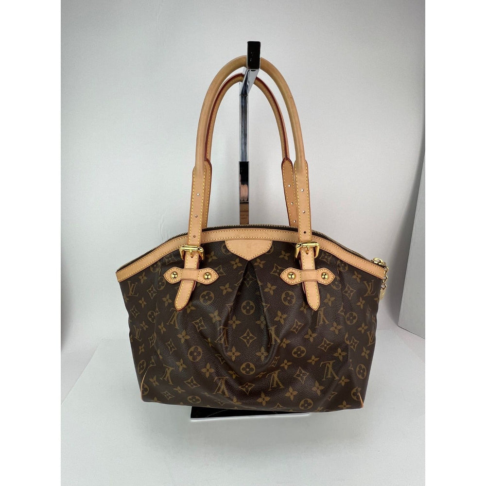 Brown handbag with beige handles on a white background