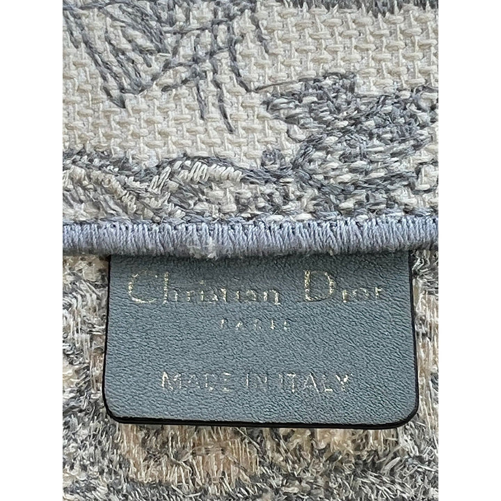 Close-up of a textured fabric with a brand label on a white background