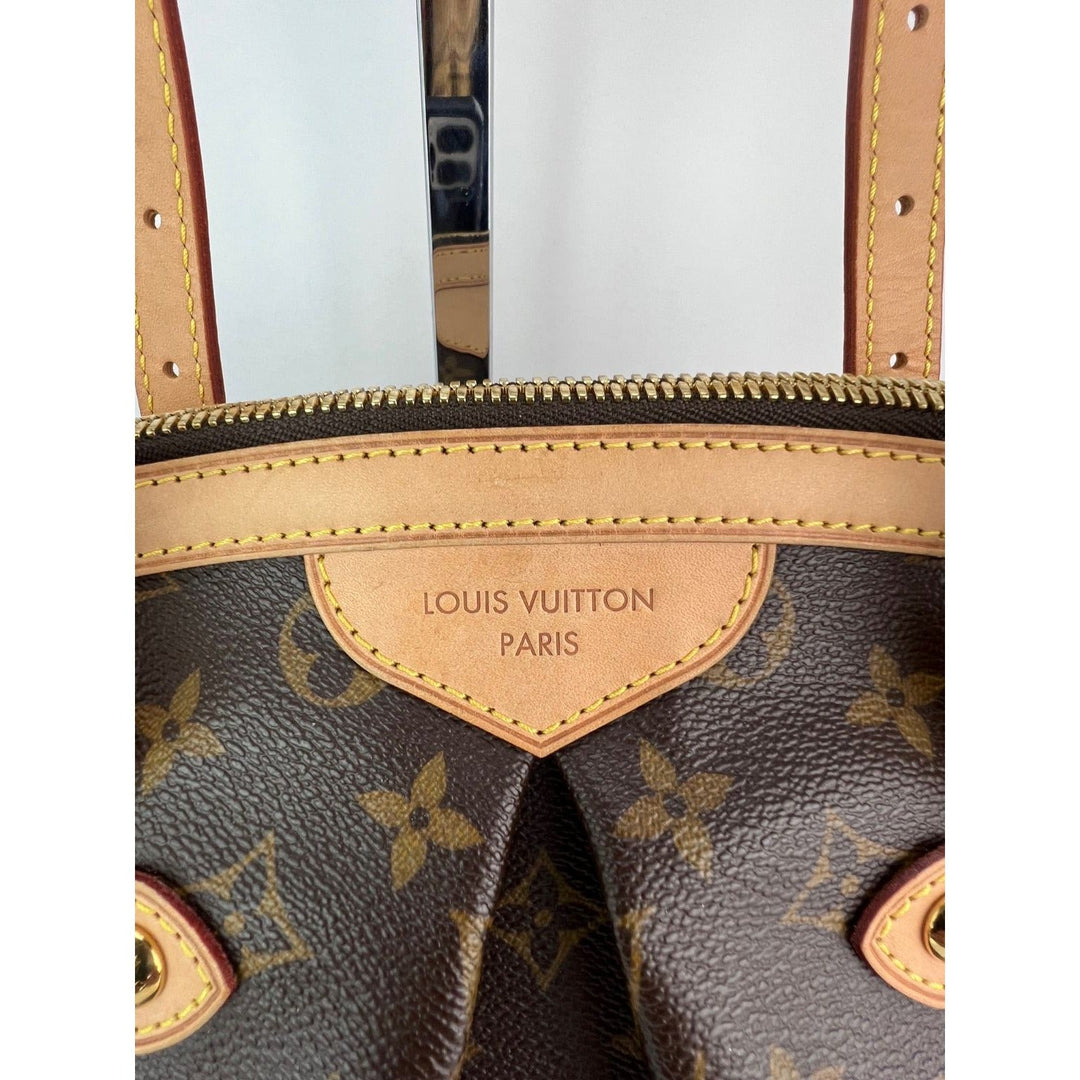 Close-up of a Louis Vuitton handbag with monogram pattern and tan leather accents.
