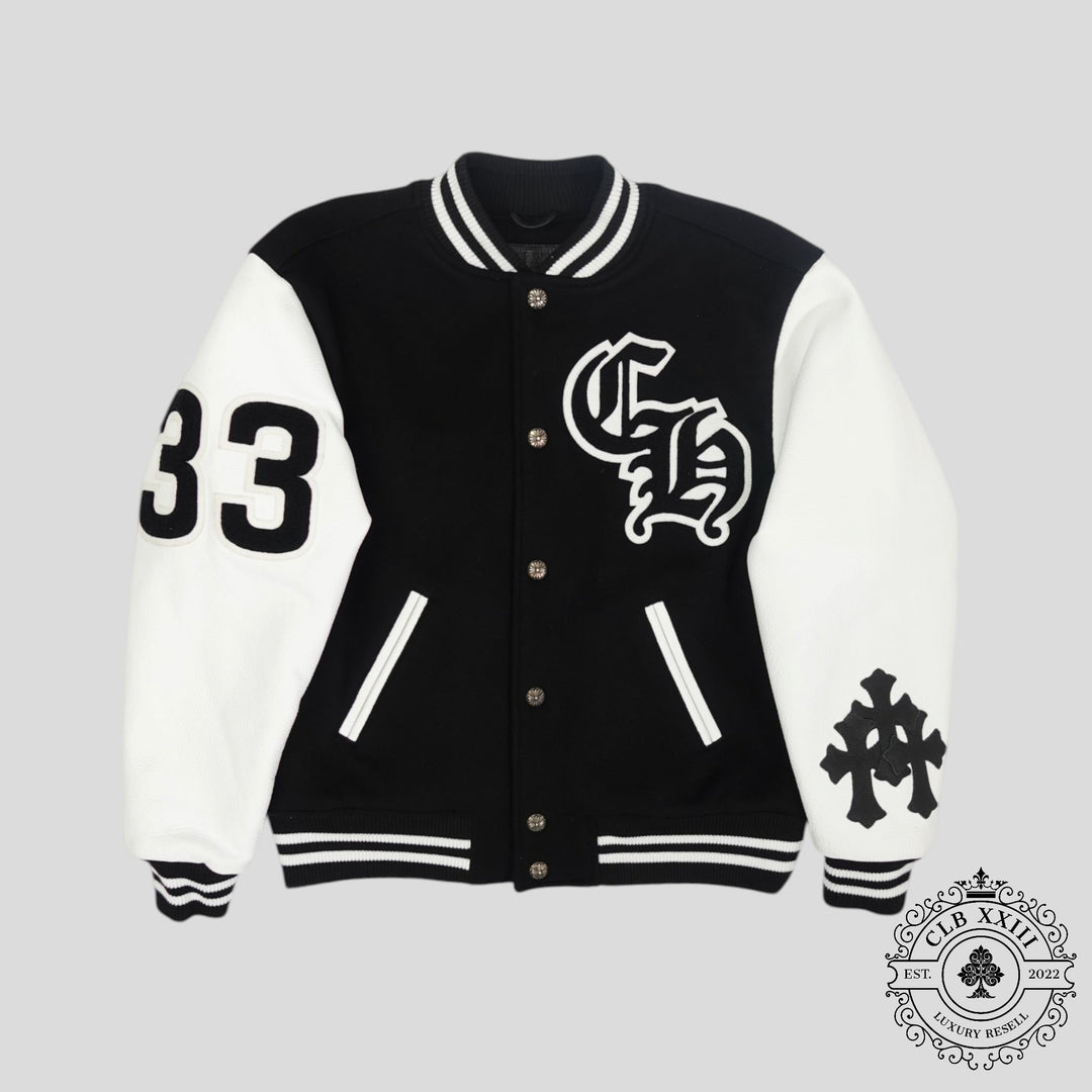 Black and white varsity jacket with logos on a gray background