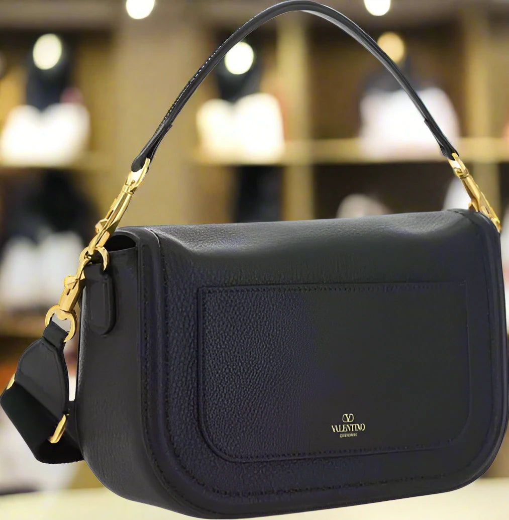 Valentino Garavani women's designer handbag in leather Luxury Valentino Garavani shoulder bag with iconic studs Valentino Garavani crossbody bag in black with gold accents