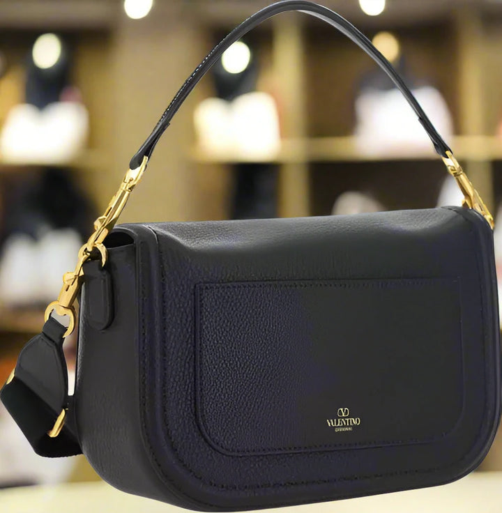 Valentino Garavani women's designer handbag in leather Luxury Valentino Garavani shoulder bag with iconic studs Valentino Garavani crossbody bag in black with gold accents