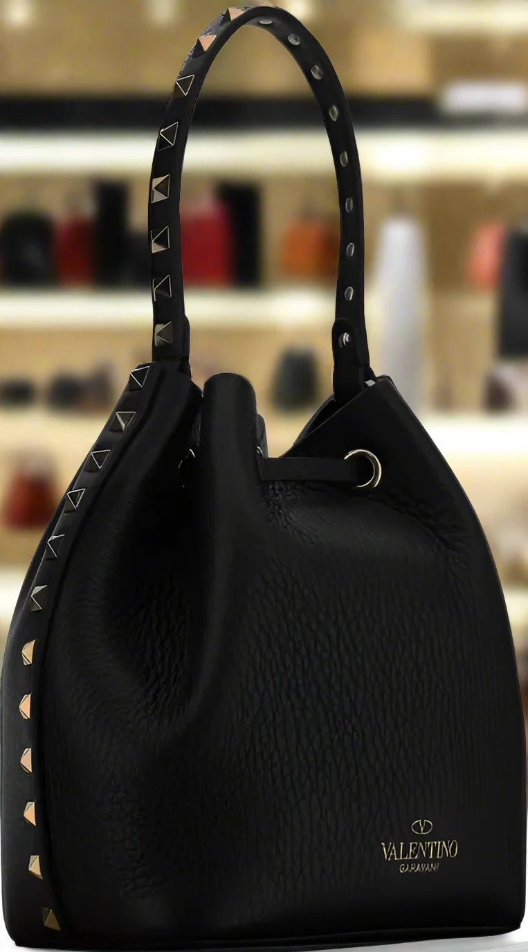 Valentino Garavani women's designer handbag in leather Luxury Valentino Garavani shoulder bag with iconic studs Valentino Garavani crossbody bag in black with gold accents