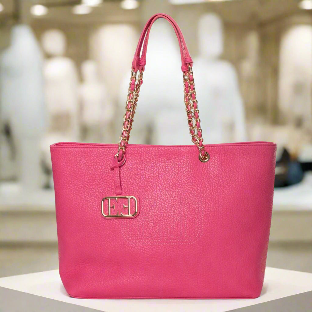 Pink handbag with a chain detail on a white background