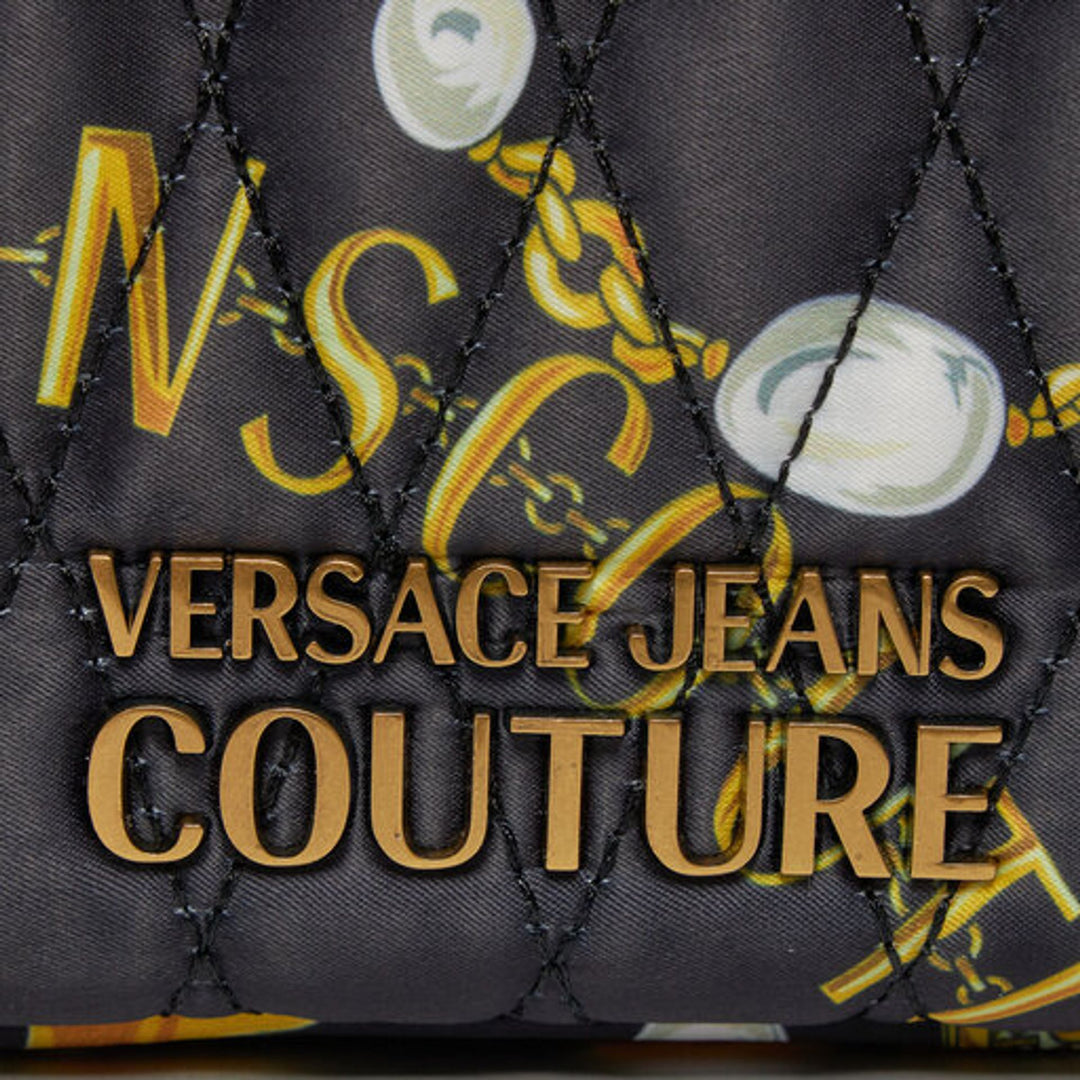Close-up of Versace Jeans Couture logo on synthetic leather shoulder bag with gold emblem, showcasing luxury design.