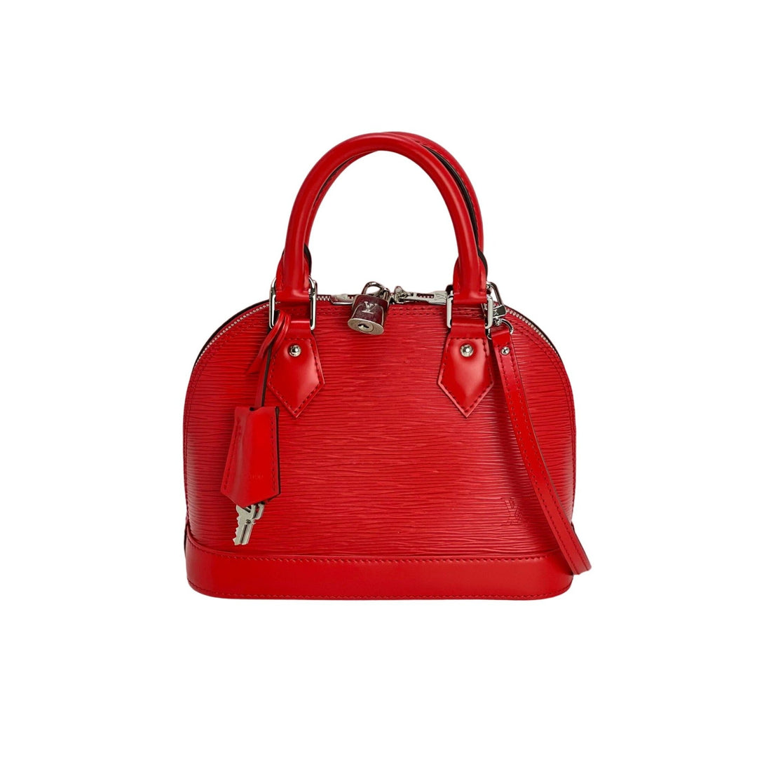 Red handbag with gold accents on a white background