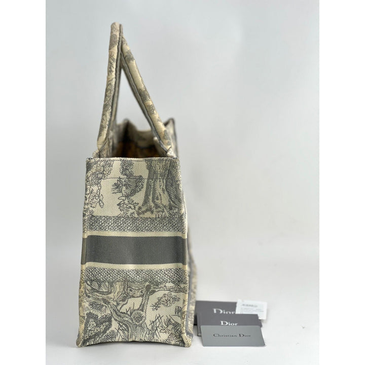 Designer handbag with floral pattern and 'Dior' tag on a white background