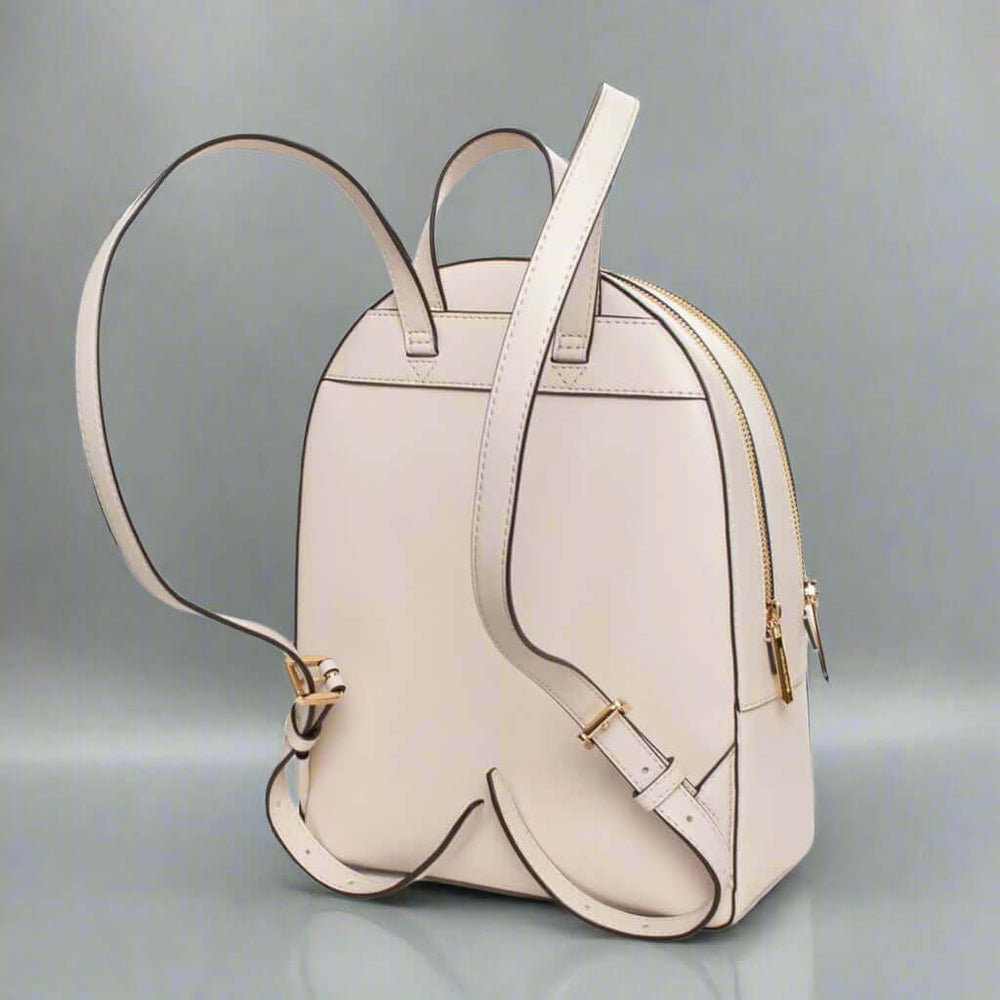 Beige backpack with gold accents on a white background