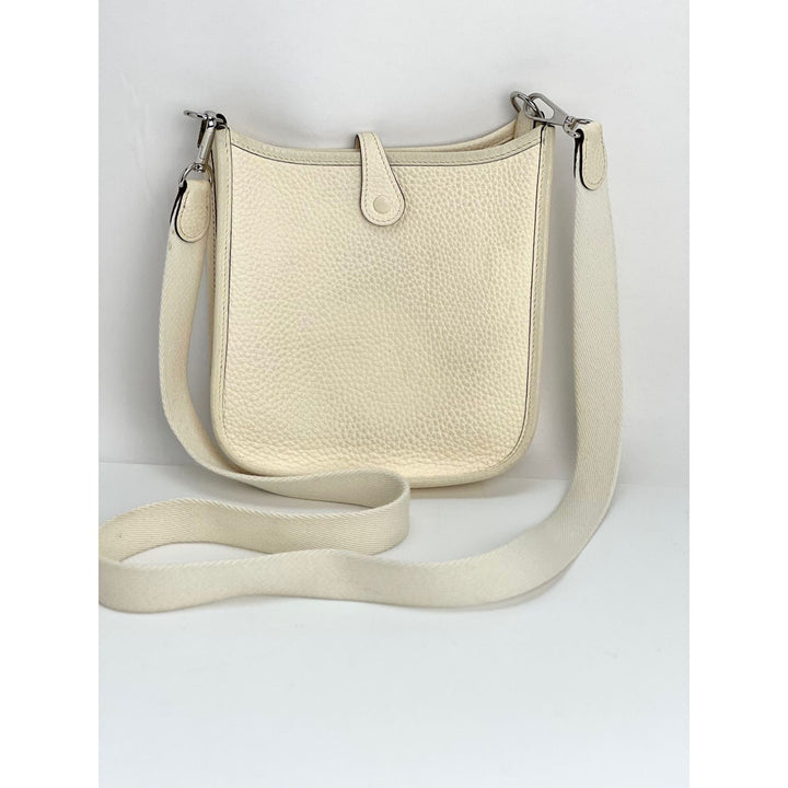 Beige leather crossbody bag on a light gray background