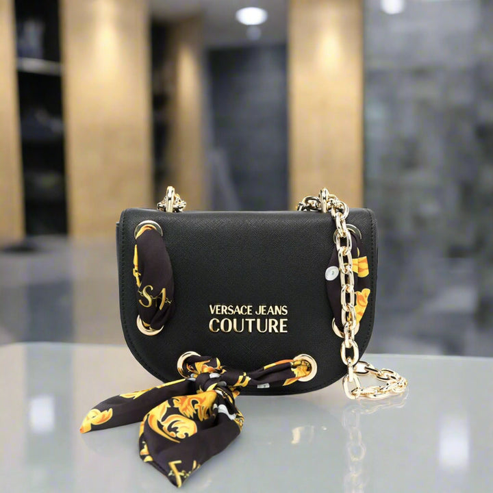 Versace Jeans Couture shoulder bag in black with gold emblem and decorative scarf, stylish synthetic leather crossbody handbag.