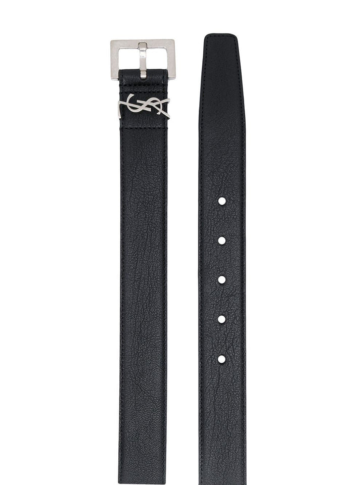 Black leather strap with silver buckle on a white background
