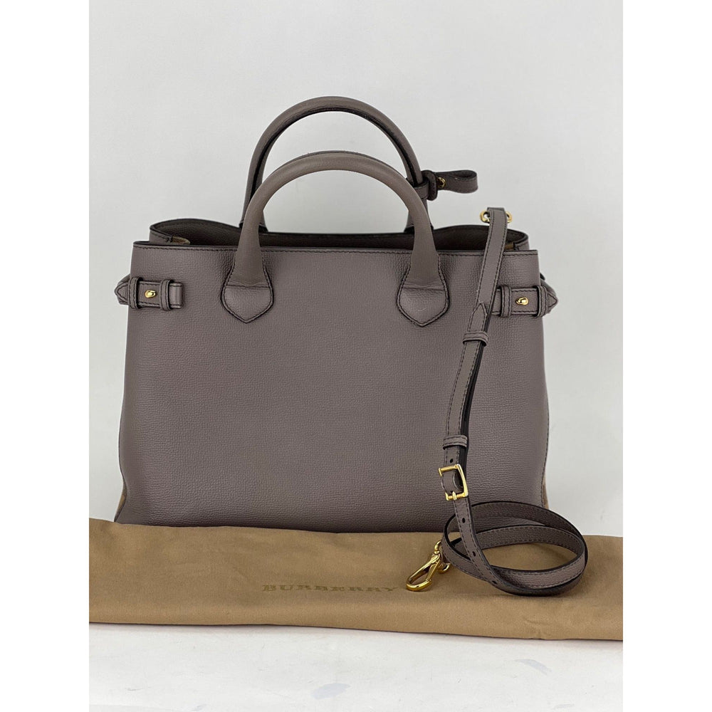 Gray handbag with a strap on a white background