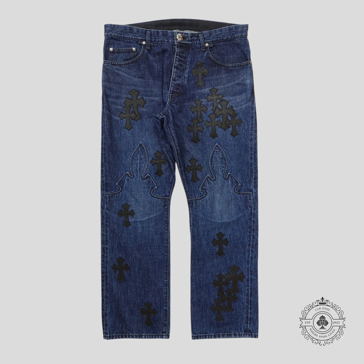 Blue jeans with black cross patterns on a gray background