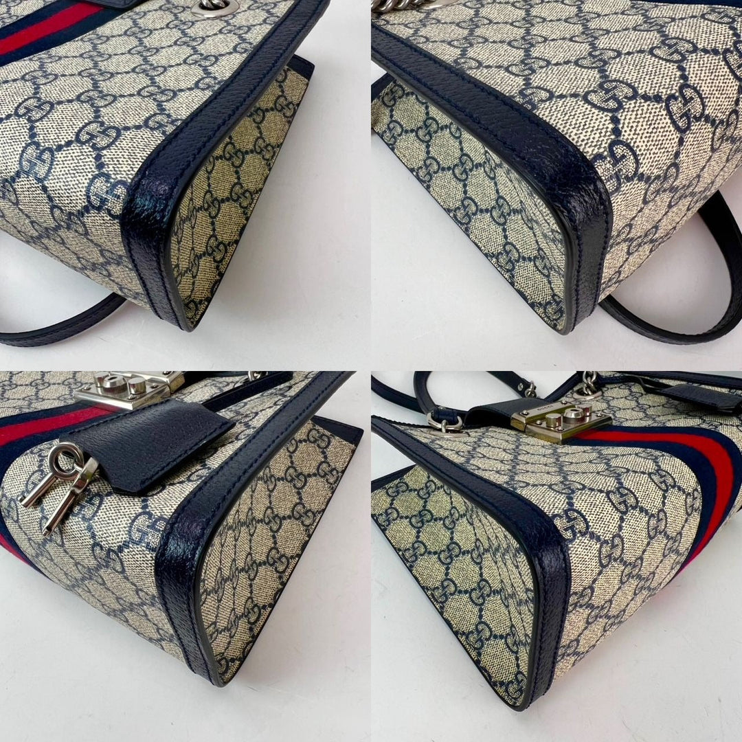 Gucci GG Supreme Dollar Calfskin Web Small Padlock Navy Tote with silver hardware and double chain handles.