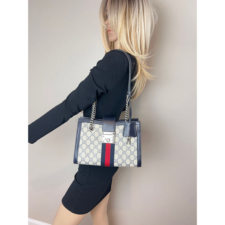Gucci GG Supreme Dollar Calfskin Web Small Padlock Navy Tote held by a model, showcasing luxury bags style.