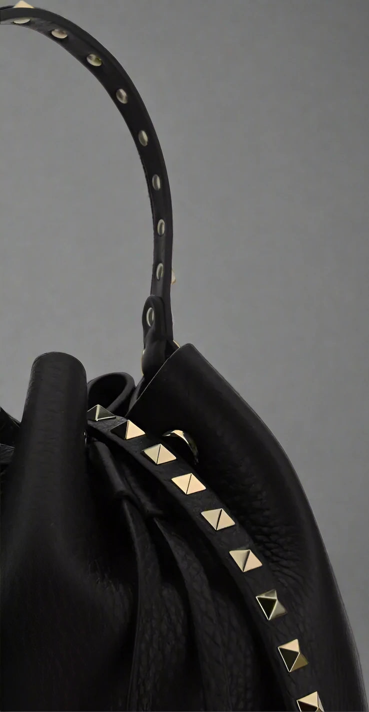 Valentino Garavani women's designer handbag in leather Luxury Valentino Garavani shoulder bag with iconic studs Valentino Garavani crossbody bag in black with gold accents
