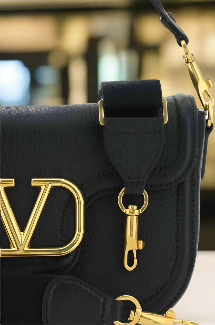 Valentino Garavani women's designer handbag in leather Luxury Valentino Garavani shoulder bag with iconic studs Valentino Garavani crossbody bag in black with gold accents
