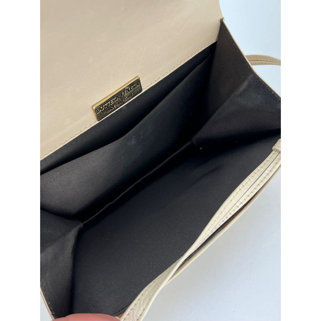 Interior view of Bottega Veneta Intreciato white leather Shoulder Clutch Bag showcasing brown satin lining and brand tag.