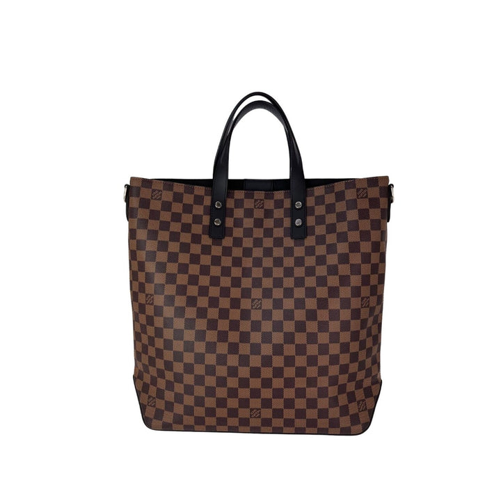 Brown checkered tote bag with black handles on a white background