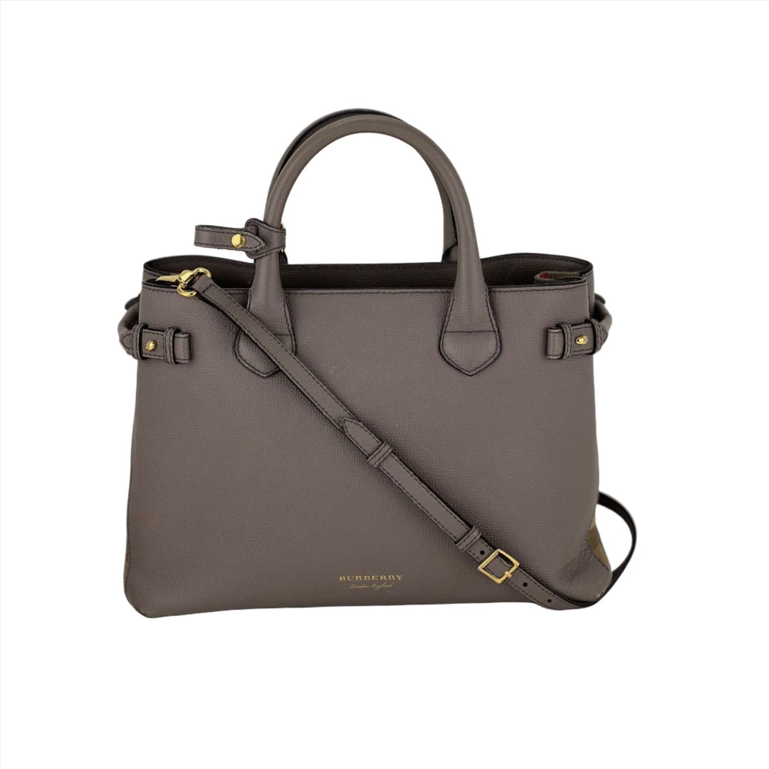 Gray handbag with a shoulder strap on a white background