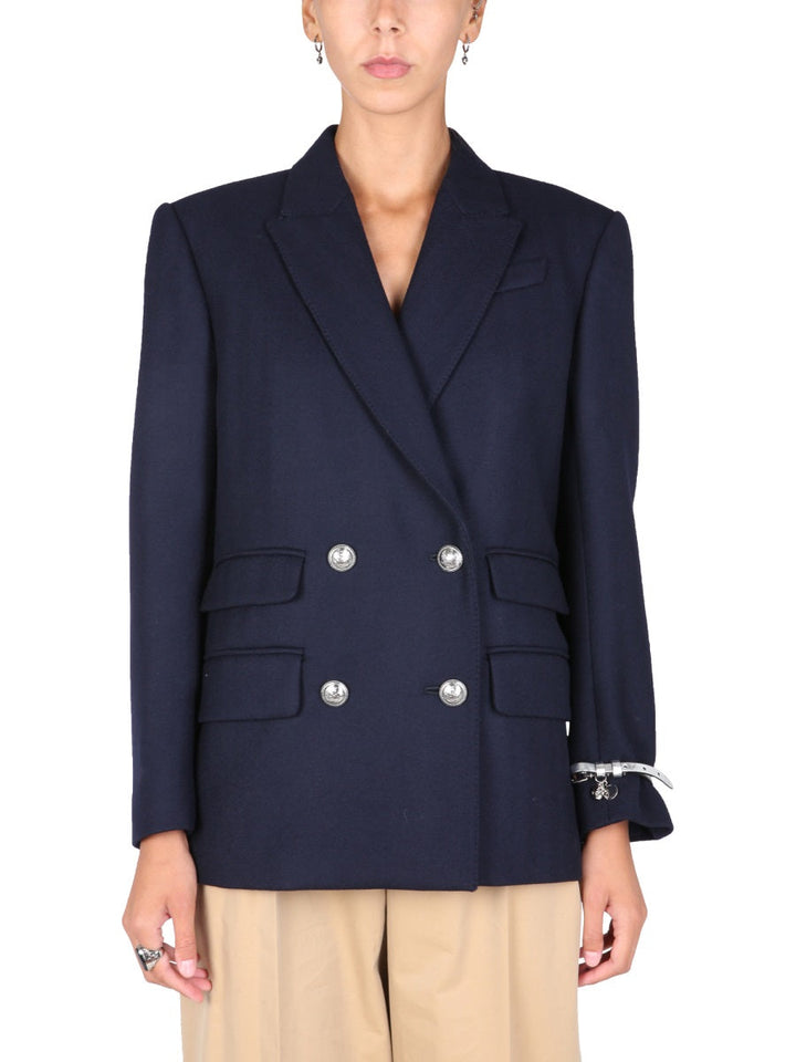 Navy blue blazer with silver buttons worn by a person on a white background