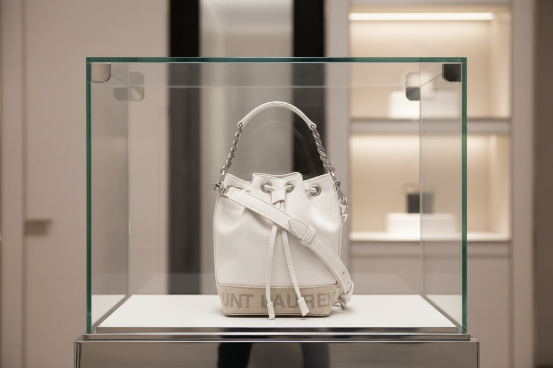 White handbag with chain detail on a white background