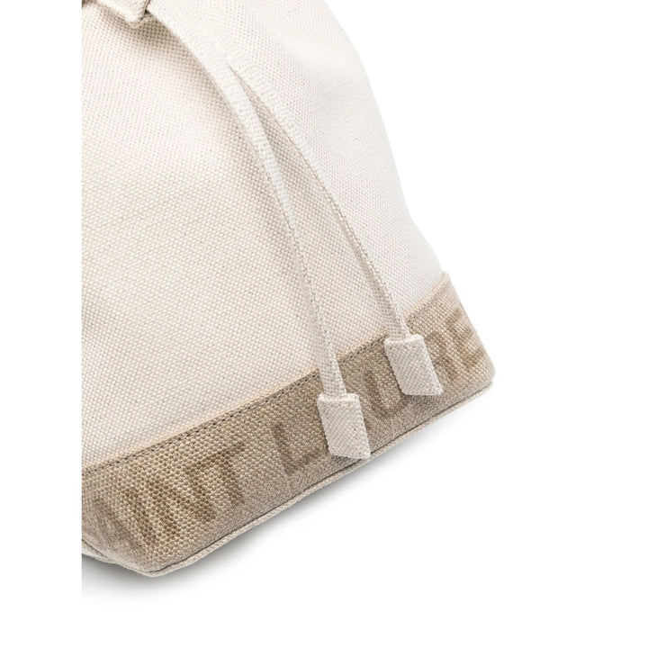 Close-up of a beige baby hat with white buttons on a white background