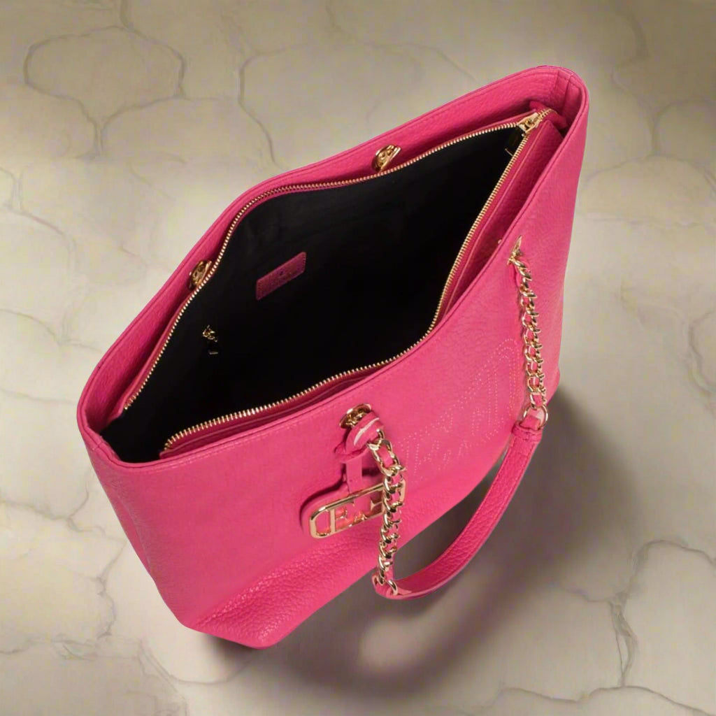 Pink handbag with gold chain strap on a white background