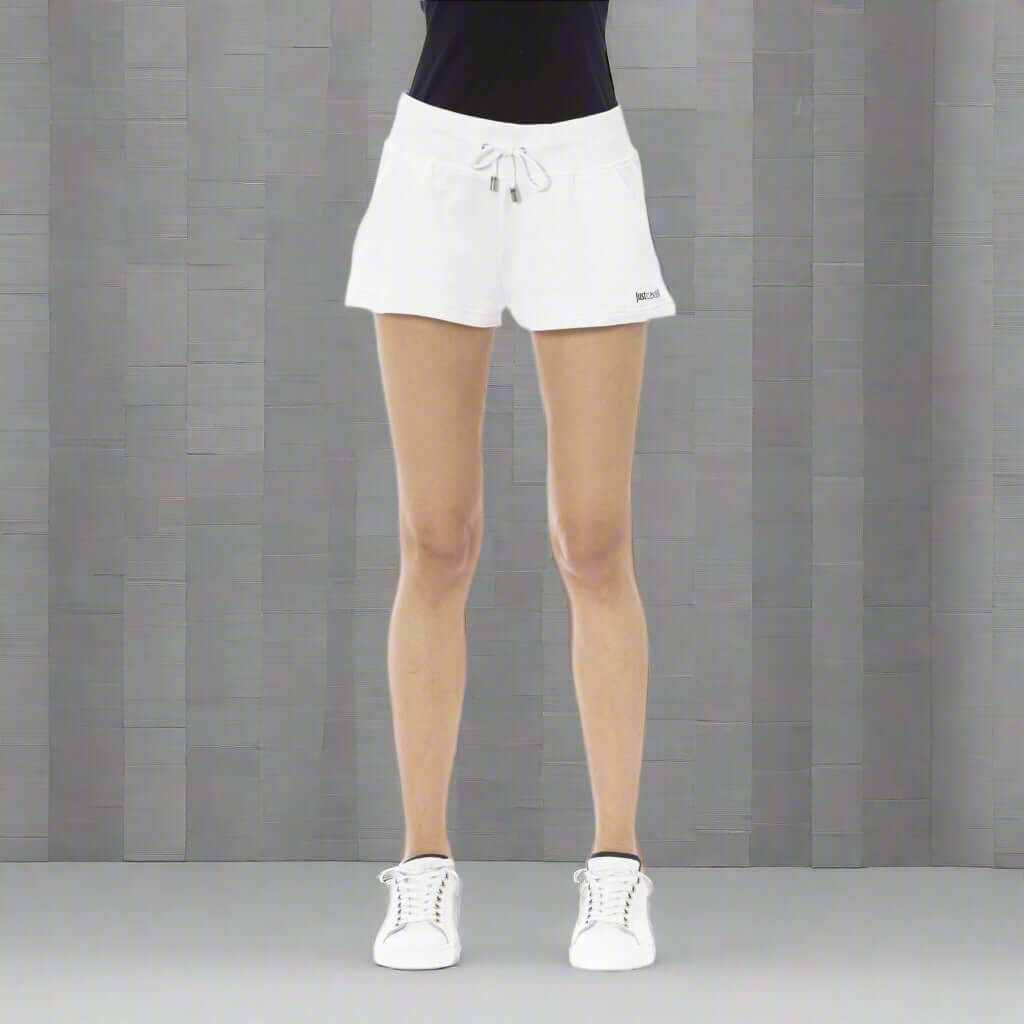 White athletic shorts worn by a person on a white background