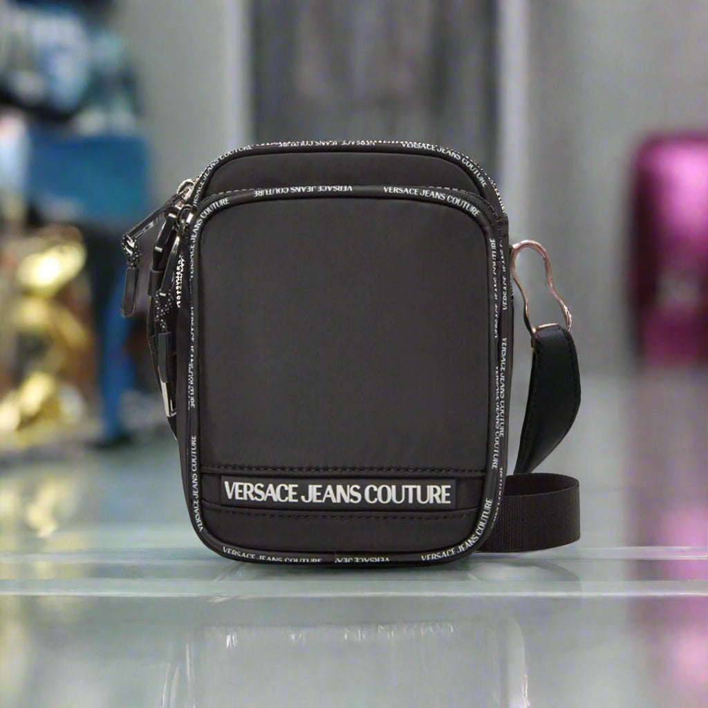 Versace Jeans Couture crossbody bag in black, featuring adjustable strap and visible logo, stylish synthetic leather design.
