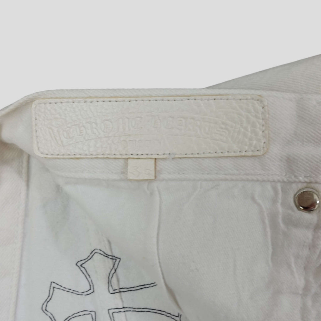 Chrome Hearts Levis Cross Patch Jeans in White / Leopard logo detail showing luxury branding.