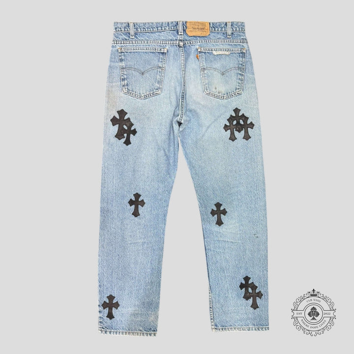 Chrome Hearts Levis Cross Patch Jeans showcasing rare light wash with black crosses, a luxurious piece in excellent condition.