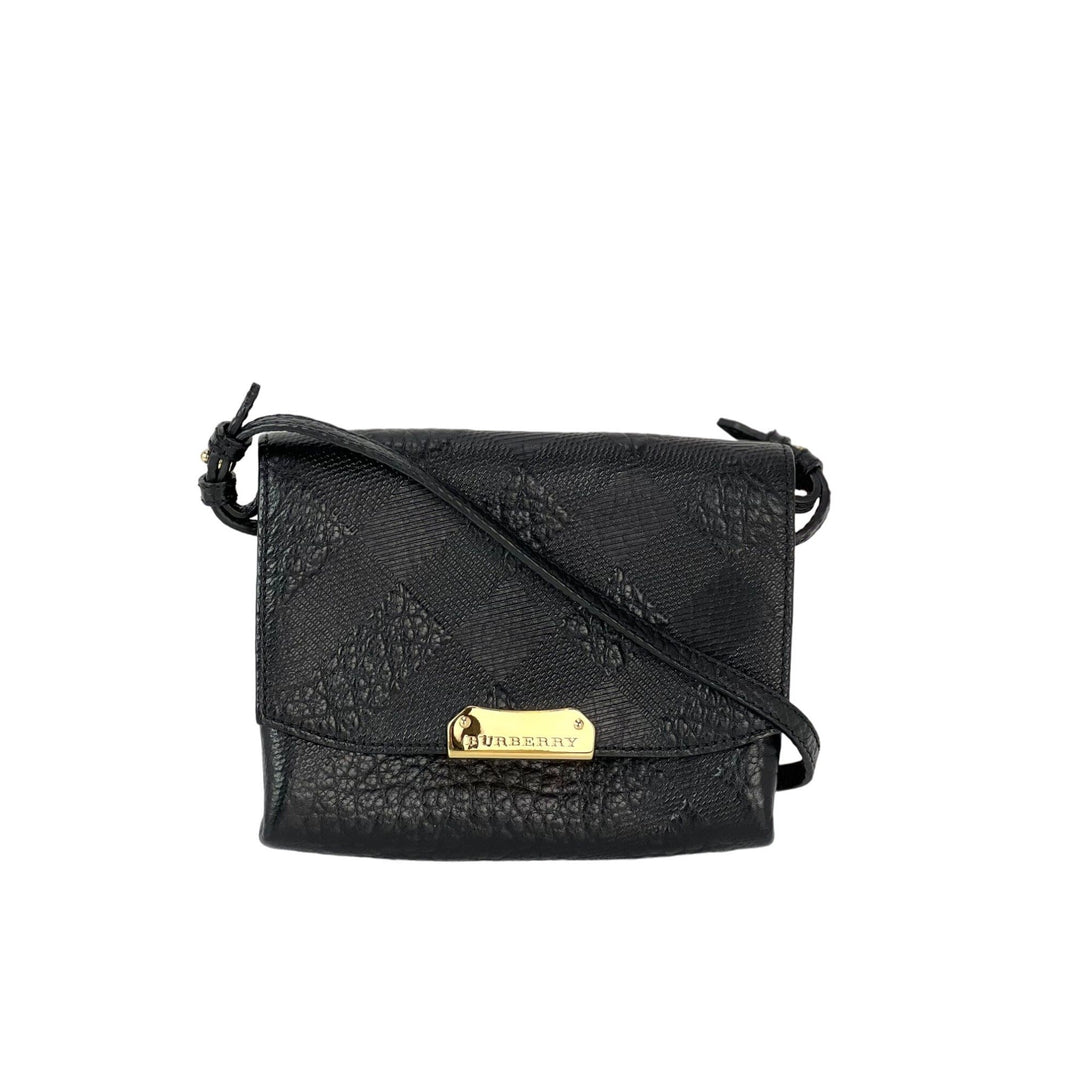Black textured crossbody bag with a gold tag on a white background