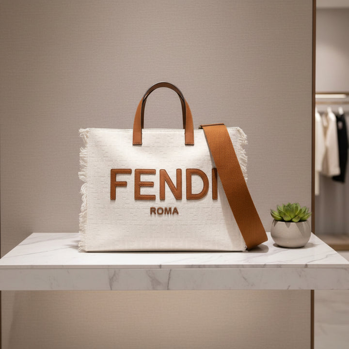 Fendi bag with brown handle and strap on a white background