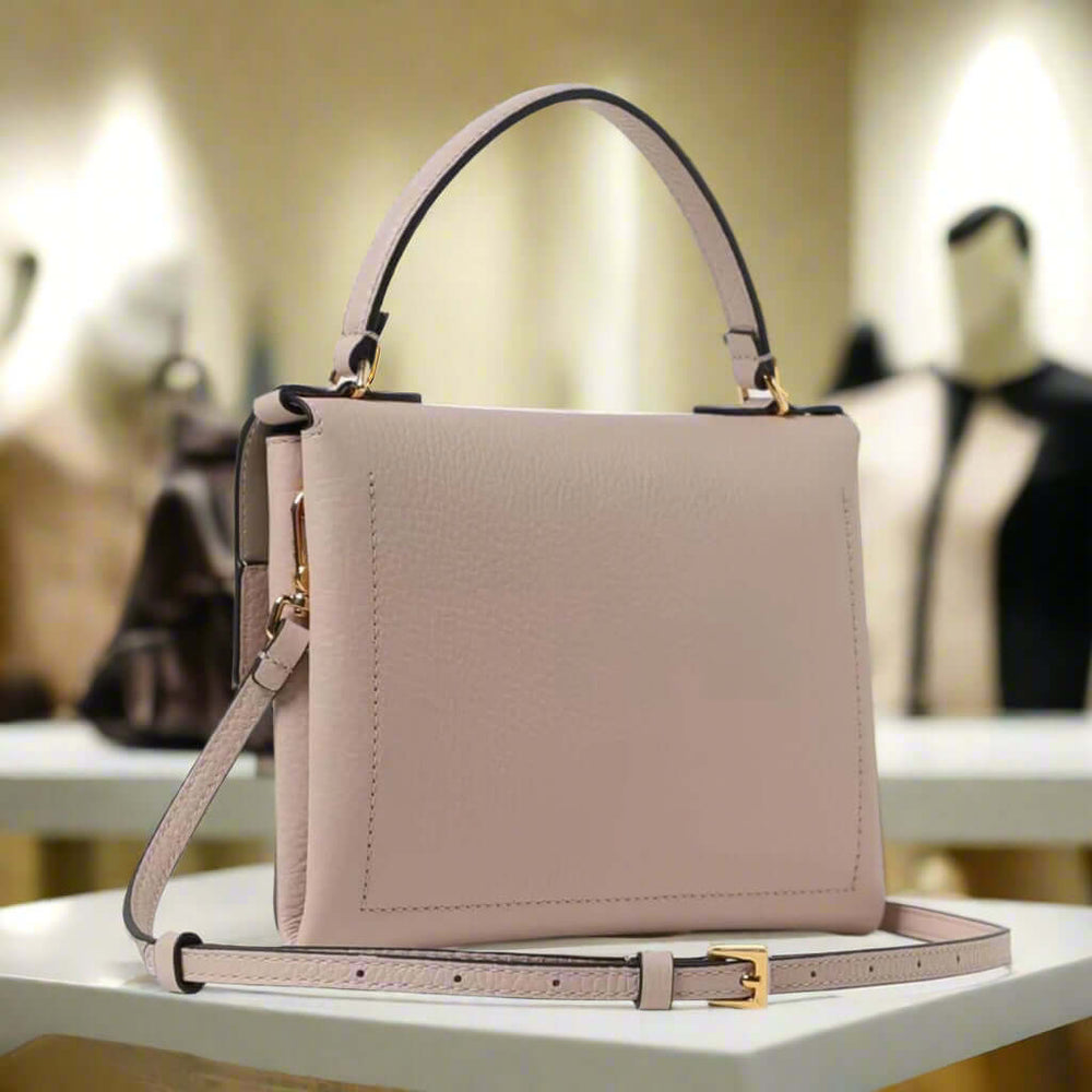 Beige handbag with a strap on a white background